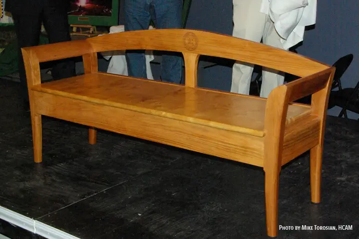Wooden bench on a dark stage.