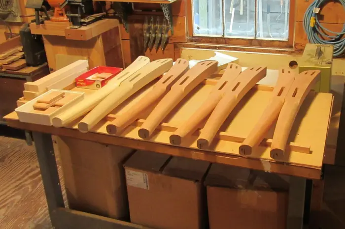 Wooden chair parts on a workshop table.
