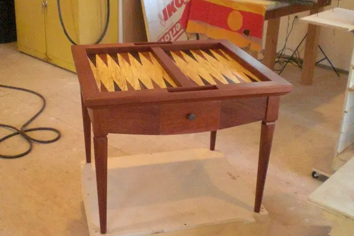 Wooden table with built-in backgammon board.