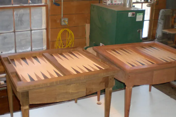Wooden backgammon tables in a workshop.