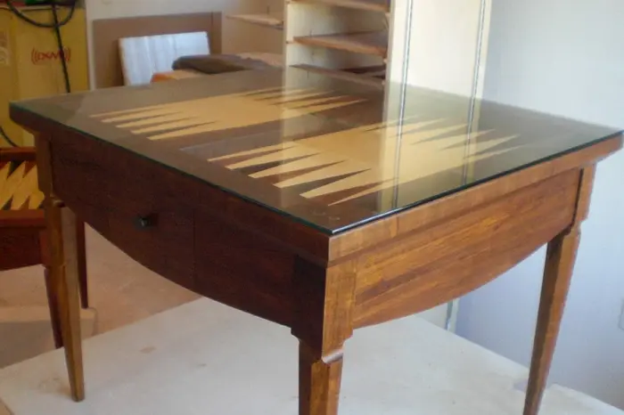 Wooden table with backgammon board design.