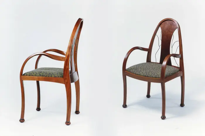 Elegant wooden chairs with cushioned seats.