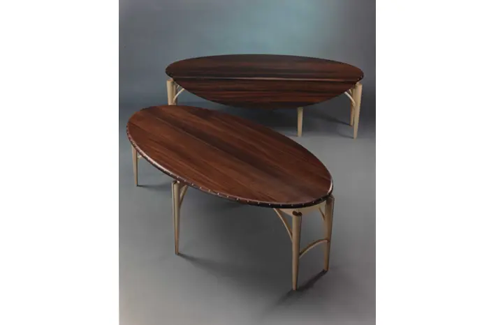 Two wooden oval tables with light legs.