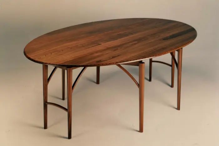 Oval wooden table with curved legs.
