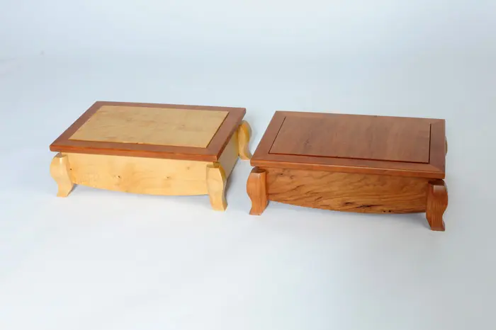 Two wooden boxes on a white background.