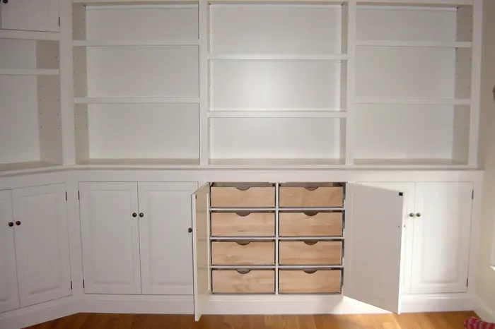 White cabinets with open shelves and drawers.