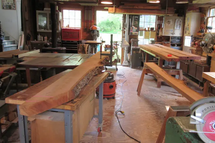 Woodworking shop with large wooden tables.