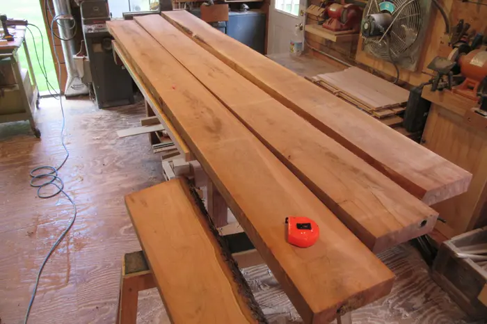 Wooden planks and tape measure in workshop.